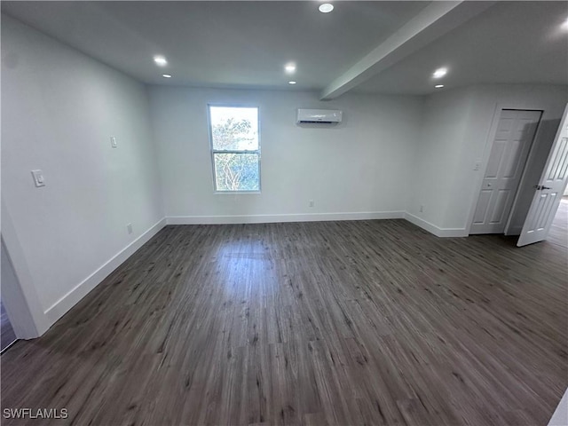 5981 Cubles Dr, Bokeelia, FL 33922 - unfurnished room with an AC wall unit, baseboards, dark wood finished floors, and recessed lighting