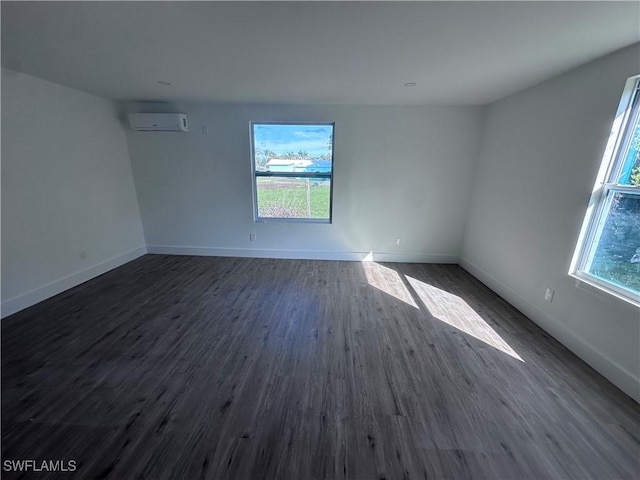 5981 Cubles Dr, Bokeelia, FL 33922 - spare room with a wall unit AC, dark wood-style flooring, and baseboards