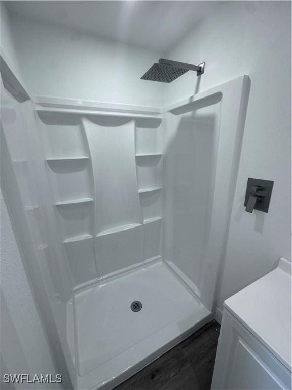 5981 Cubles Dr, Bokeelia, FL 33922 - full bath featuring a shower and wood finished floors