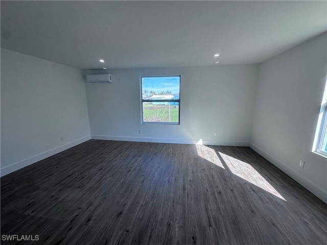 5981 Cubles Dr, Bokeelia, FL 33922 - unfurnished room with an AC wall unit, plenty of natural light, dark wood-style flooring, baseboards, and recessed lighting