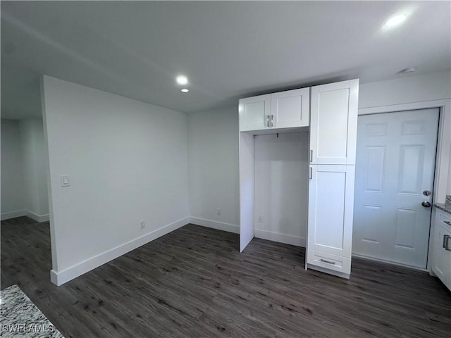 5981 Cubles Dr, Bokeelia, FL 33922 - unfurnished bedroom with dark wood-style flooring, baseboards, and recessed lighting