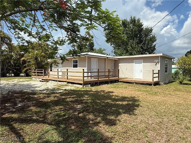 5981 Cubles Dr, Bokeelia, FL 33922 - rear view of property with a deck and a yard