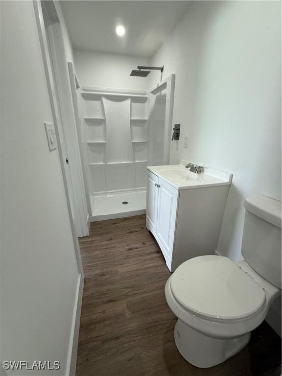 5981 Cubles Dr, Bokeelia, FL 33922 - bathroom with wood finished floors, a shower, vanity, and recessed lighting