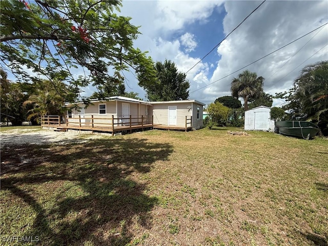 5981 Cubles Dr, Bokeelia, FL 33922 - view of grassy yard featuring a deck and a storage shed