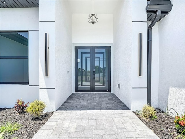 323 NE 19th Ter, Cape Coral, FL 33909 - view of exterior entry featuring french doors and stucco siding