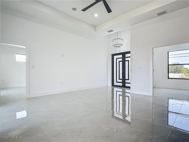 323 NE 19th Ter, Cape Coral, FL 33909 - spare room featuring a ceiling fan, baseboards, and a towering ceiling