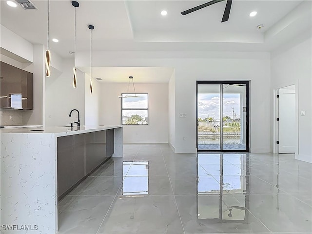 323 NE 19th Ter, Cape Coral, FL 33909 - kitchen featuring modern cabinets, a tray ceiling, light countertops, a ceiling fan, and recessed lighting