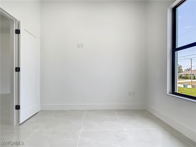 323 NE 19th Ter, Cape Coral, FL 33909 - spare room featuring baseboards and light tile patterned floors