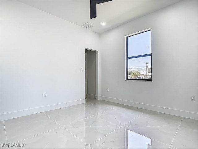 323 NE 19th Ter, Cape Coral, FL 33909 - spare room featuring baseboards, recessed lighting, and light marble finish floors