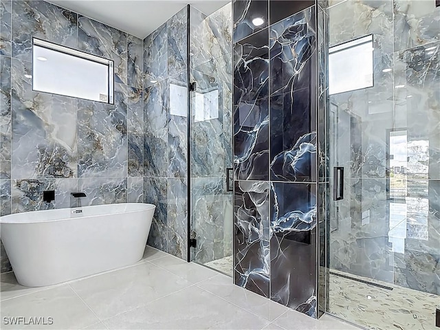 323 NE 19th Ter, Cape Coral, FL 33909 - bathroom with plenty of natural light, a freestanding tub, tile walls, and a shower stall