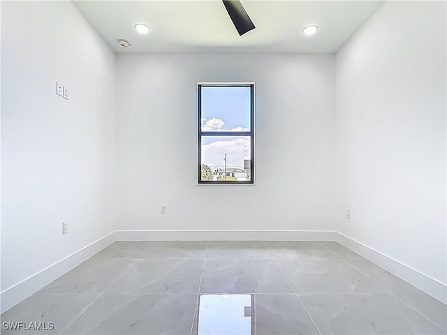 323 NE 19th Ter, Cape Coral, FL 33909 - empty room featuring baseboards and light marble finish flooring