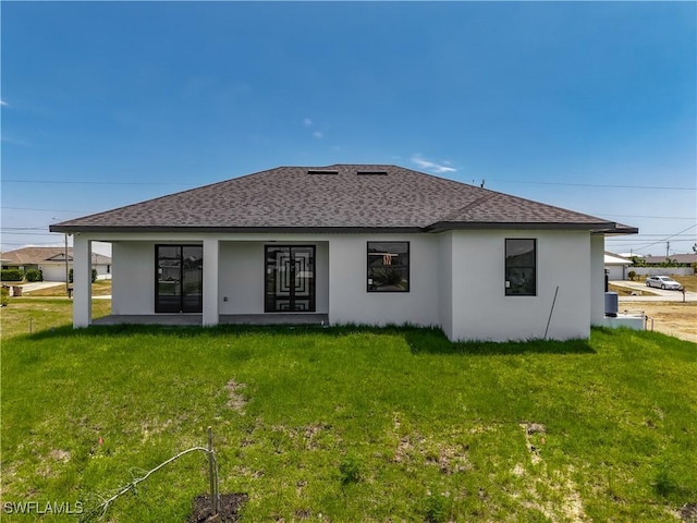 323 NE 19th Ter, Cape Coral, FL 33909 - rear view of house featuring roof with shingles, a yard, and stucco siding