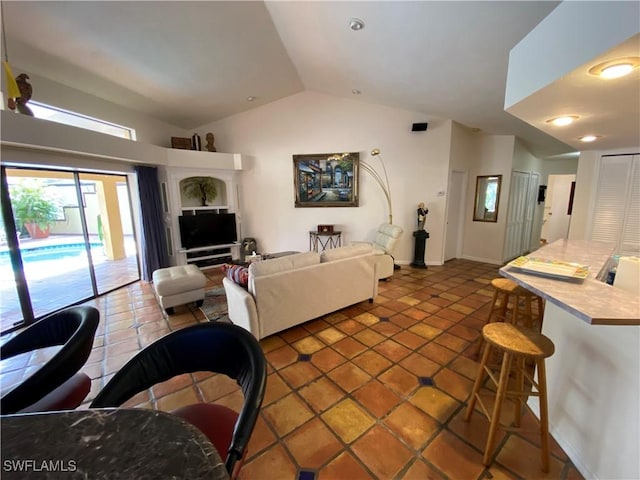 19966 Lake Vista Cir, Lehigh Acres, FL 33936 - living room with lofted ceiling, tile patterned flooring, and baseboards