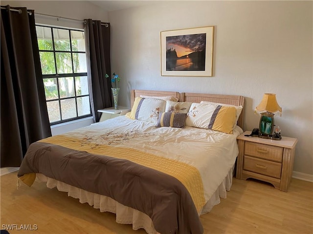 19966 Lake Vista Cir, Lehigh Acres, FL 33936 - bedroom featuring light wood-style floors, lofted ceiling, and baseboards