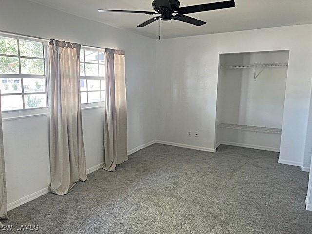 521 Pennview Ave, Lehigh Acres, FL 33936 - unfurnished bedroom featuring carpet floors, baseboards, a ceiling fan, and a closet