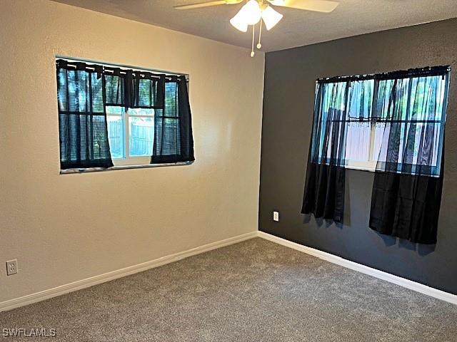 521 Pennview Ave, Lehigh Acres, FL 33936 - unfurnished room featuring ceiling fan, carpet, and baseboards