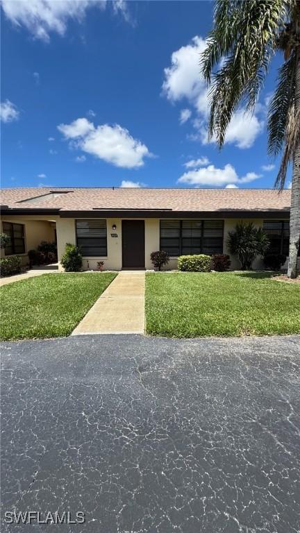 3916 SE 11th Pl Unit 503, Cape Coral, FL 33904 - ranch-style house with a front lawn and stucco siding