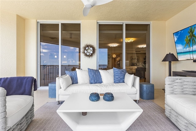 14270 Royal Harbour Ct Unit 920, Fort Myers, FL 33908 - living area featuring a ceiling fan and a textured wall