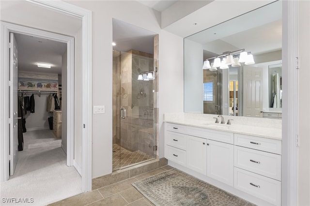 14270 Royal Harbour Ct Unit 920, Fort Myers, FL 33908 - bathroom featuring a stall shower, vanity, a spacious closet, and tile patterned floors