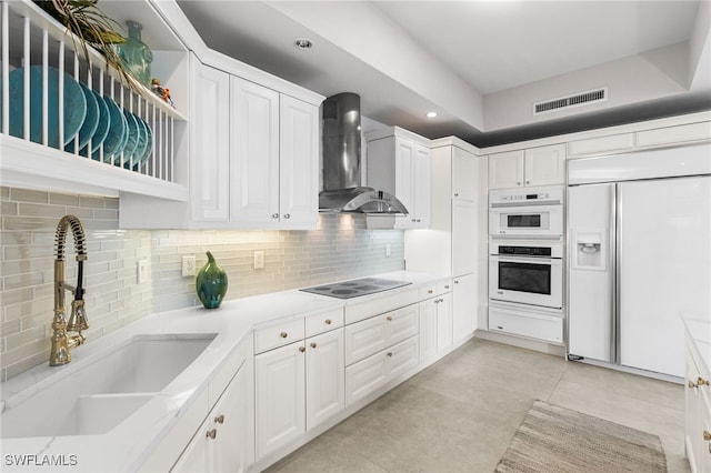 14270 Royal Harbour Ct Unit 920, Fort Myers, FL 33908 - kitchen with wall chimney range hood, paneled fridge, black electric stovetop, a sink, and a warming drawer