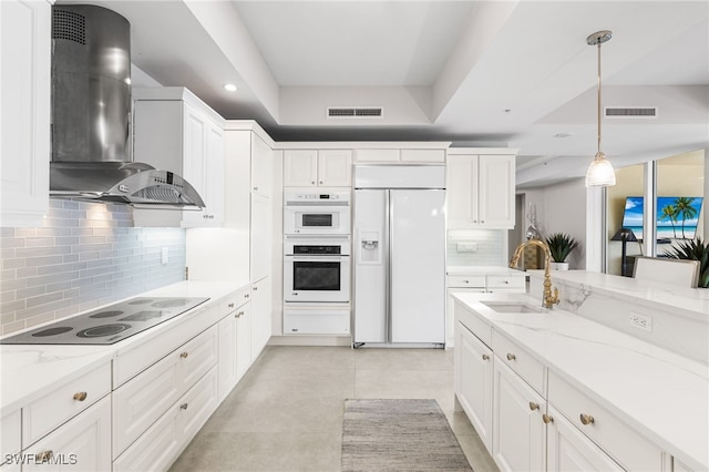 14270 Royal Harbour Ct Unit 920, Fort Myers, FL 33908 - kitchen featuring paneled refrigerator, wall chimney range hood, a sink, black electric cooktop, and backsplash