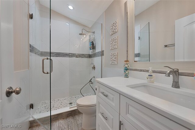 607 92nd Ave N, Naples, FL 34108 - full bathroom with a stall shower, toilet, vaulted ceiling, and vanity