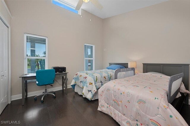 607 92nd Ave N, Naples, FL 34108 - bedroom with wood finished floors, baseboards, a ceiling fan, a desk, and a high ceiling