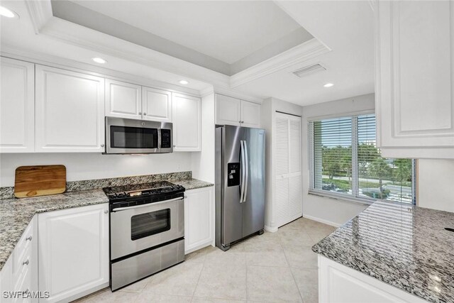 255 Park Shore Dr Unit 3-341, Naples, FL 34103 - kitchen featuring stainless steel appliances, a tray ceiling, white cabinets, recessed lighting, and light stone counters