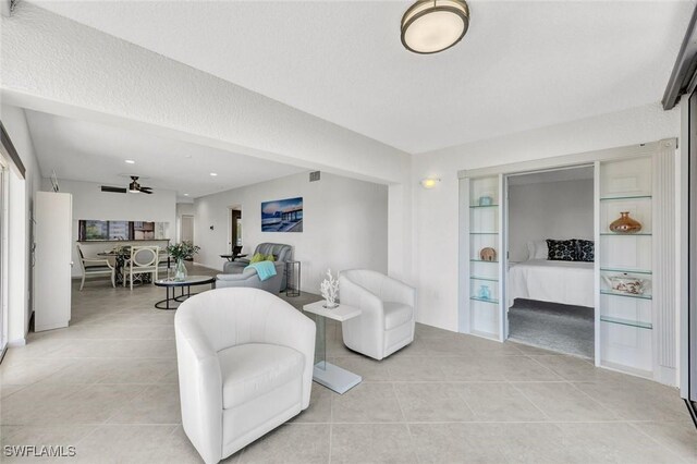 255 Park Shore Dr Unit 3-341, Naples, FL 34103 - living room with light tile patterned floors and a ceiling fan
