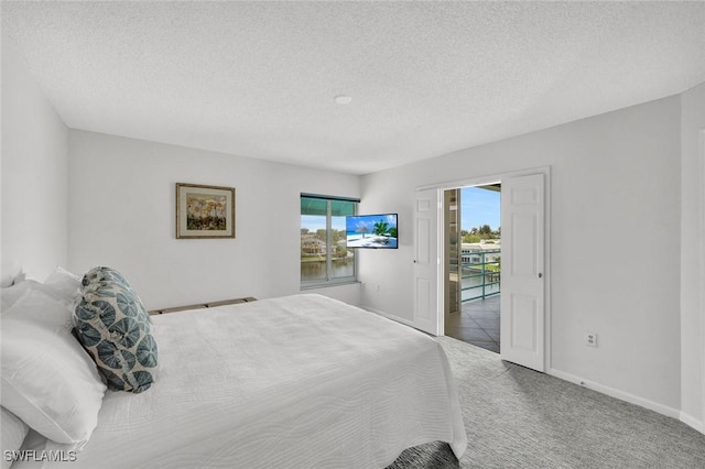 255 Park Shore Dr Unit 3-341, Naples, FL 34103 - carpeted bedroom with a textured ceiling and baseboards
