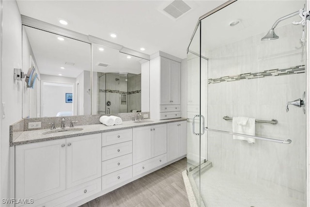 255 Park Shore Dr Unit 3-341, Naples, FL 34103 - full bathroom featuring a shower stall, double vanity, and recessed lighting