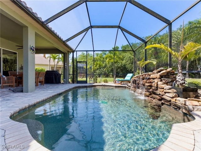 13708 Collina Ct, Estero, FL 33928 - swimming pool featuring a patio area, a ceiling fan, and glass enclosure