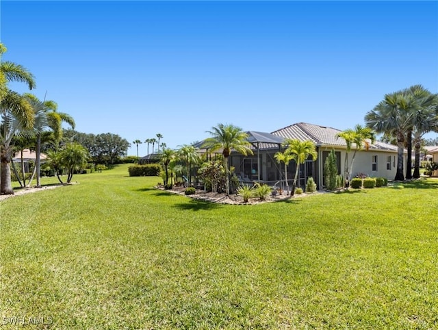13708 Collina Ct, Estero, FL 33928 - view of grassy yard with a lanai