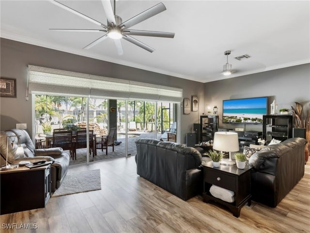 13708 Collina Ct, Estero, FL 33928 - living area with crown molding, wood finished floors, healthy amount of natural light, and ceiling fan