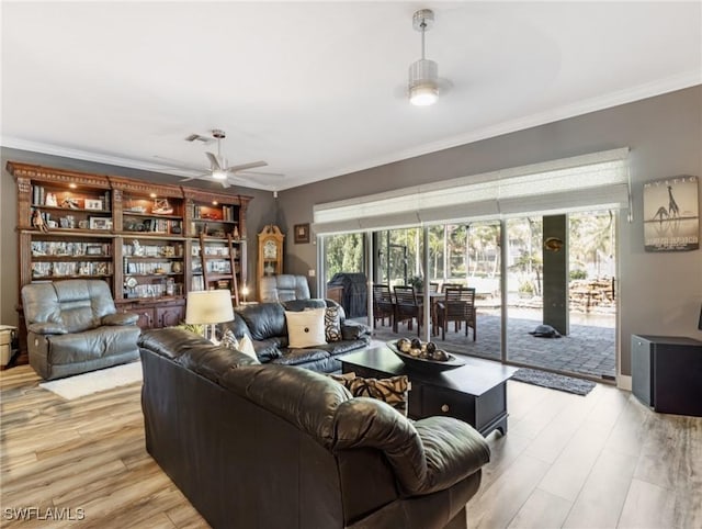 13708 Collina Ct, Estero, FL 33928 - living room featuring a ceiling fan, ornamental molding, healthy amount of natural light, and light wood-type flooring