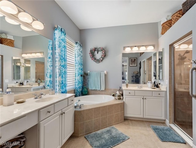 13708 Collina Ct, Estero, FL 33928 - bathroom featuring a shower stall, tile patterned flooring, a garden tub, and two vanities