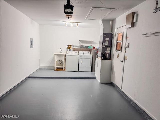 2016 Mariner Ct, Labelle, FL 33935 - garage featuring washing machine and clothes dryer, heating unit, a garage door opener, electric panel, and electric water heater