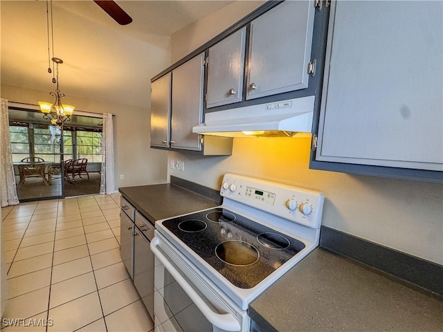 2016 Mariner Ct, Labelle, FL 33935 - kitchen featuring white electric stove, under cabinet range hood, dark countertops, light tile patterned floors, and decorative light fixtures