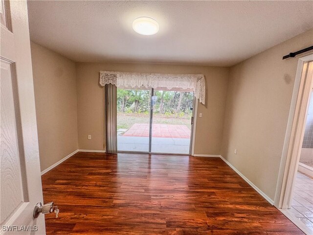2016 Mariner Ct, Labelle, FL 33935 - spare room featuring wood finished floors, baseboards, and a textured ceiling