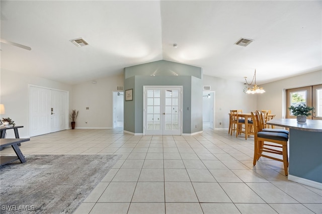 227 Manasota St, Fort Myers, FL 33913 - living room featuring french doors, vaulted ceiling, light tile patterned floors, a chandelier, and baseboards