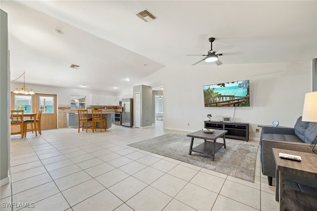 227 Manasota St, Fort Myers, FL 33913 - living room featuring lofted ceiling, light tile patterned flooring, a ceiling fan, baseboards, and a chandelier