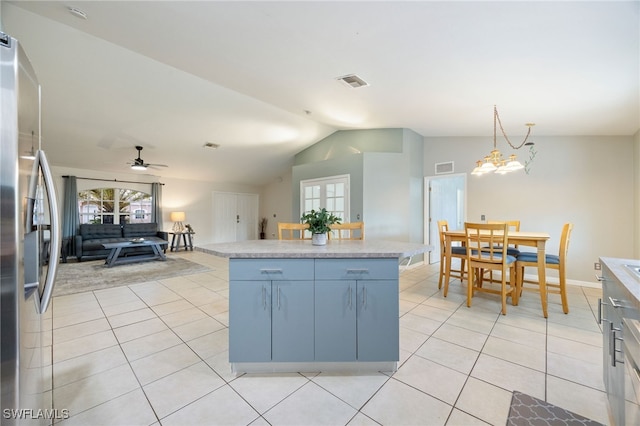 227 Manasota St, Fort Myers, FL 33913 - kitchen with vaulted ceiling, light tile patterned floors, freestanding refrigerator, open floor plan, and light countertops