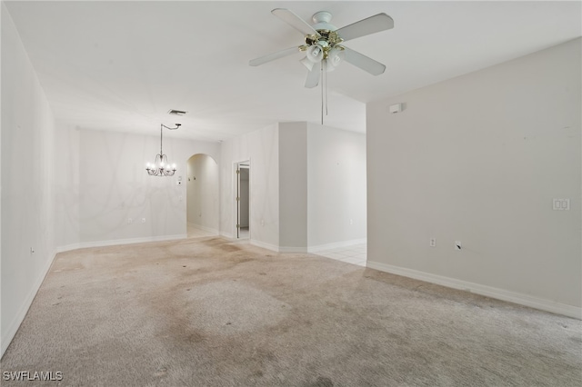 8380 Big Acorn Cir Unit 12A, Naples, FL 34119 - empty room featuring light carpet, arched walkways, ceiling fan, and a chandelier