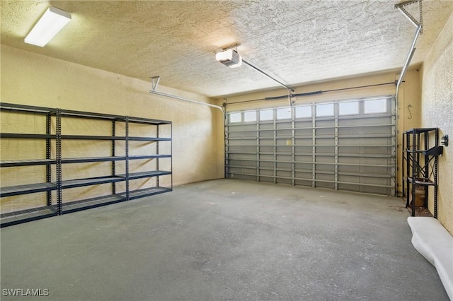 8380 Big Acorn Cir Unit 12A, Naples, FL 34119 - garage featuring a garage door opener and a textured wall