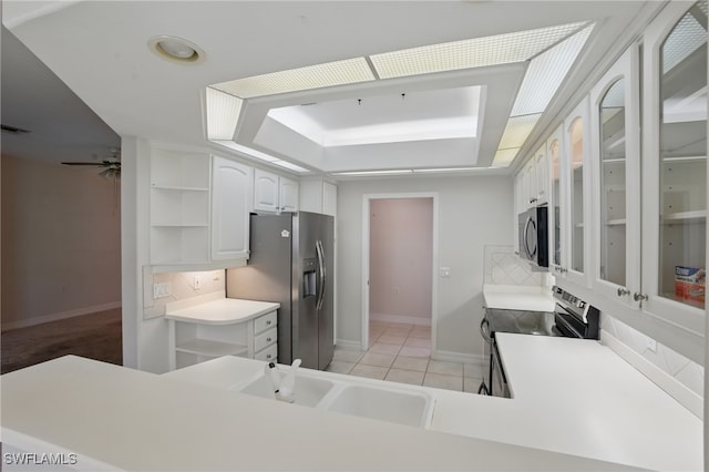 8380 Big Acorn Cir Unit 12A, Naples, FL 34119 - kitchen featuring stainless steel appliances, open shelves, baseboards, white cabinets, and a sink