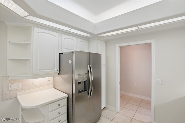8380 Big Acorn Cir Unit 12A, Naples, FL 34119 - kitchen with open shelves, stainless steel fridge, white cabinetry, light tile patterned flooring, and backsplash
