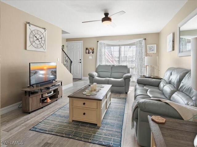 112 Marco Villas Dr Unit U2, Marco Island, FL 34145 - living area with a ceiling fan, stairs, dark wood finished floors, and baseboards