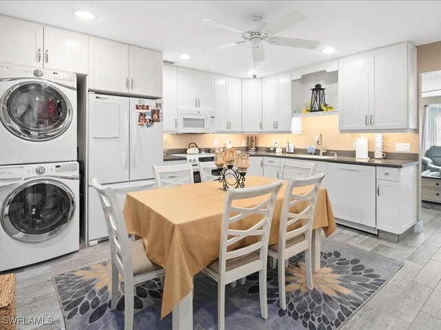 112 Marco Villas Dr Unit U2, Marco Island, FL 34145 - kitchen featuring stacked washer / dryer, white appliances, a sink, a ceiling fan, and recessed lighting