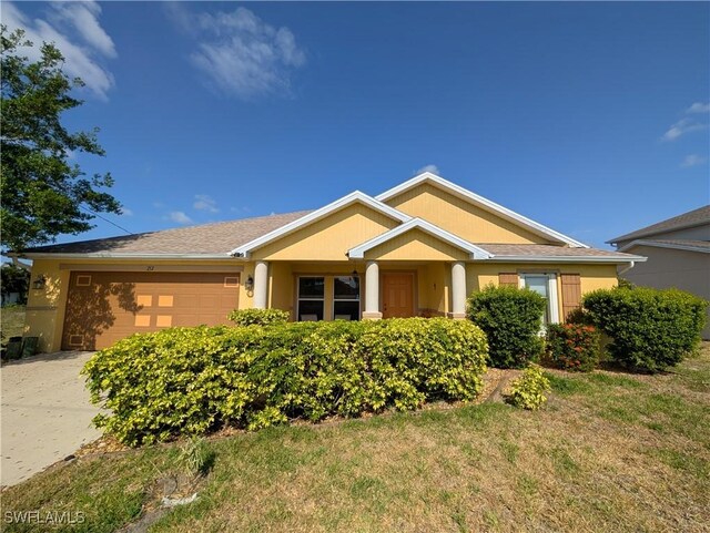 212 NW 26th Ave, Cape Coral, FL 33993 - single story home with a garage, driveway, and a front lawn