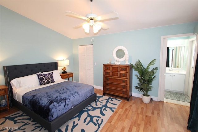 20061 Petrucka Cir N, Lehigh Acres, FL 33936 - bedroom with light wood-style flooring, a closet, baseboards, a sink, and ceiling fan